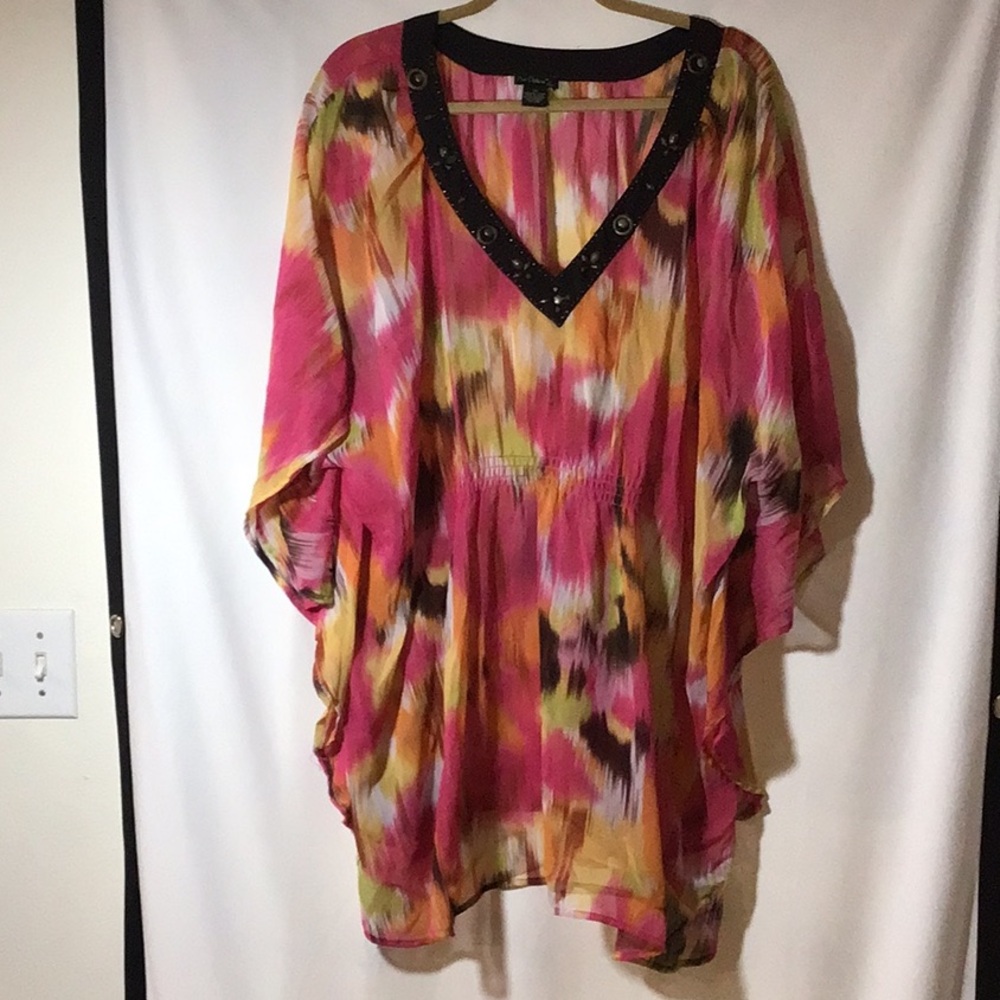 Plus size 3X sheer poncho top. 100% polyester. V neck lined w/ studs.